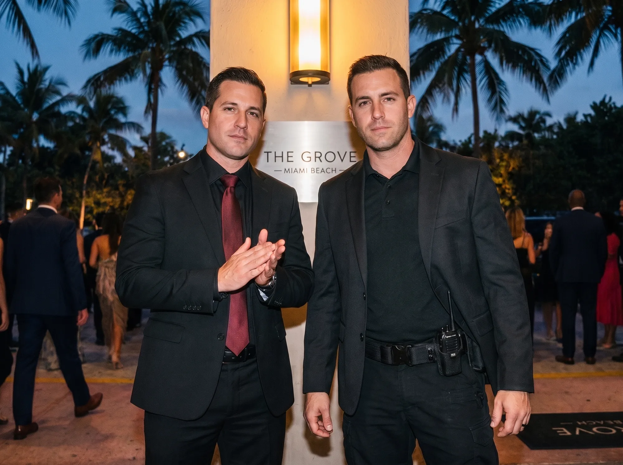 Two Prestige Guard officers posted at the entrance of a Miami Beach venue at dusk